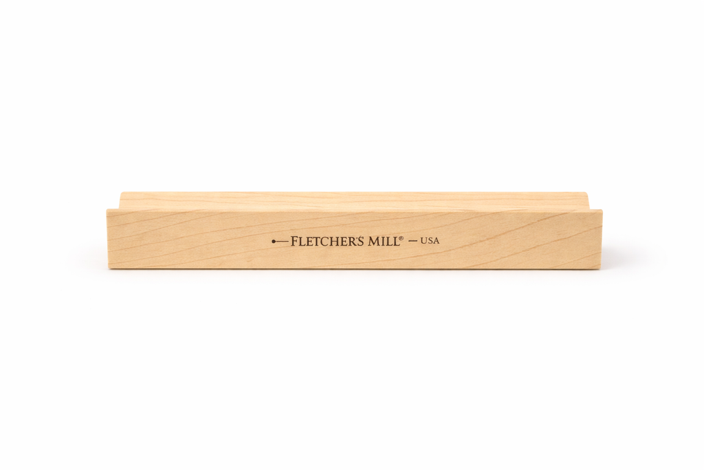 Wooden tool with 'Fletcher's Mill' branding on a white background