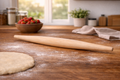 Wooden rolling pin on a flour-dusted wooden surface with a bowl of strawberries in the background.